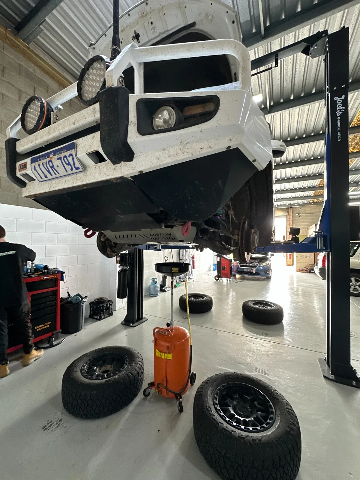 Toyota Land Cruiser Prado raised on the hoist, viewed from the front